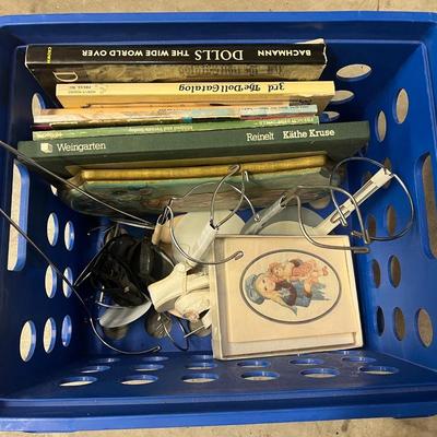 Blue crate with doll books and supplies