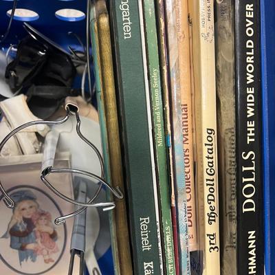 Blue crate with doll books and supplies