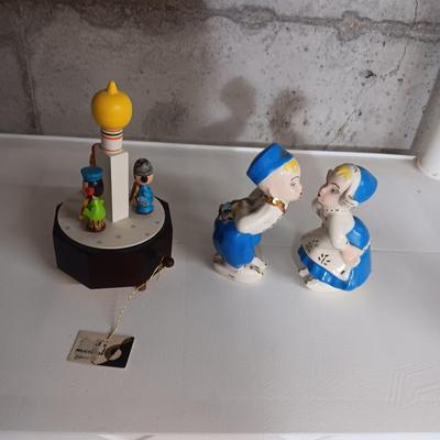 A STAUBACH KISSING DUTCH FIGURINES AND SCHMID ROTATING MUSIC BOX
