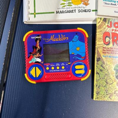 CHILDREN'S BOOKS AND 2 HAND HELD GAMES