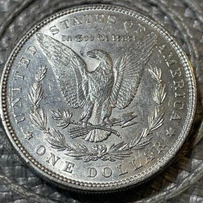 1896-P AU CONDITION/CLEANED MORGAN SILVER DOLLAR (COIN #6) AS PICTURED.
