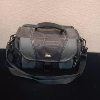 A CAMERA CASE AND A METAL BEVERAGE CUP RESEMBLING A CAMERA LENS