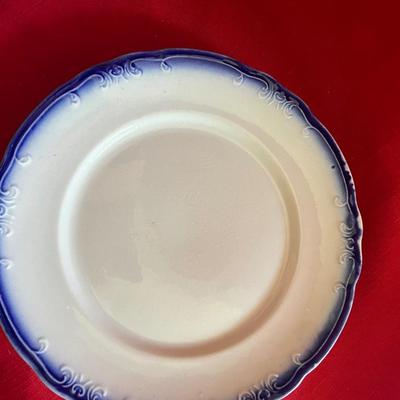 Beautiful, gold, trimmed blue, and white gravy boat along with over variety of saucers, dipping plates, and salad plates