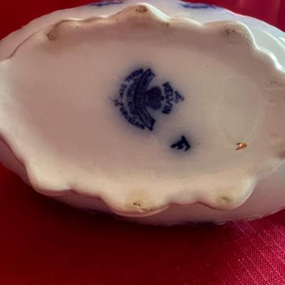 Beautiful, gold, trimmed blue, and white gravy boat along with over variety of saucers, dipping plates, and salad plates