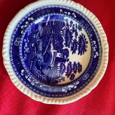Beautiful, gold, trimmed blue, and white gravy boat along with over variety of saucers, dipping plates, and salad plates