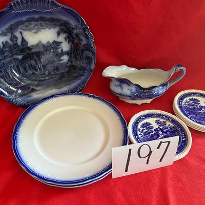 Beautiful, gold, trimmed blue, and white gravy boat along with over variety of saucers, dipping plates, and salad plates