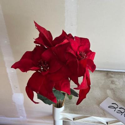 Decorative Christmas decor, flowers poinsettias, along with pinecone wreath