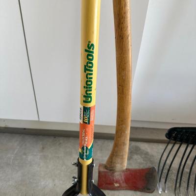 YARD TOOLS AND A WATERING CAN