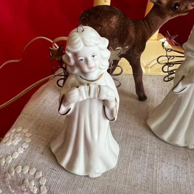 2 plastic reindeer, with three small angels that are bells A plastic candle holder that plugs into the wall and the package of small gold...
