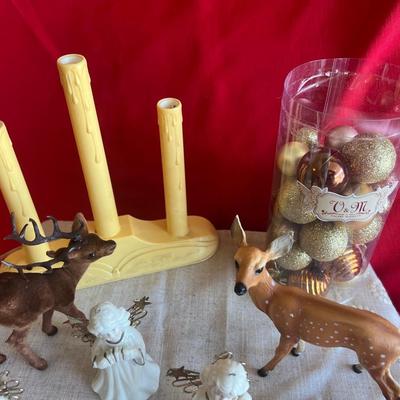 2 plastic reindeer, with three small angels that are bells A plastic candle holder that plugs into the wall and the package of small gold...