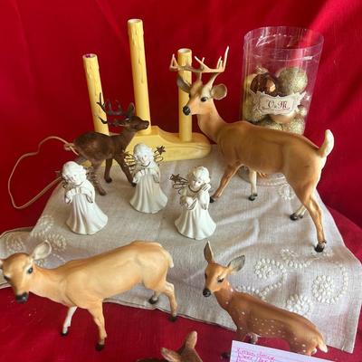 2 plastic reindeer, with three small angels that are bells A plastic candle holder that plugs into the wall and the package of small gold...