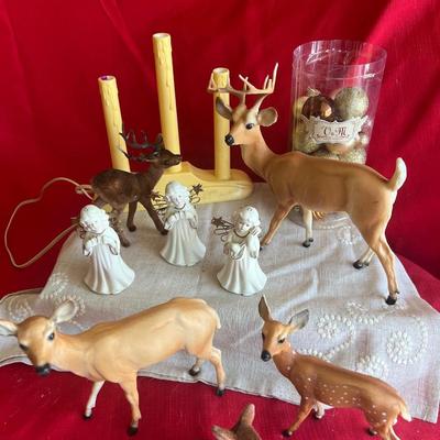2 plastic reindeer, with three small angels that are bells A plastic candle holder that plugs into the wall and the package of small gold...