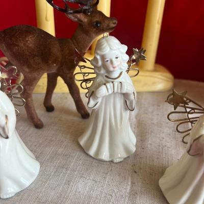 2 plastic reindeer, with three small angels that are bells A plastic candle holder that plugs into the wall and the package of small gold...