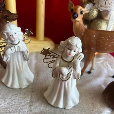 2 plastic reindeer, with three small angels that are bells A plastic candle holder that plugs into the wall and the package of small gold...