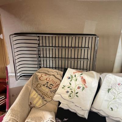 Box of eating utensils, several different sets, candles, silverware holder, and variety and doilies