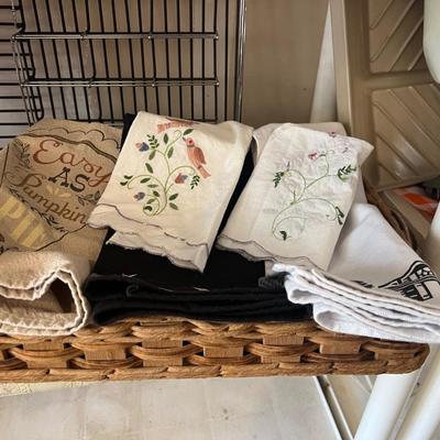 Box of eating utensils, several different sets, candles, silverware holder, and variety and doilies