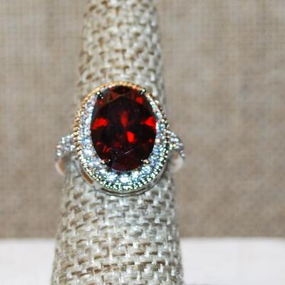 Size 6 Large Oval Red Faceted Stone Ring with Full Oval Surround Stones on a Silver Tone Band 4.7g)