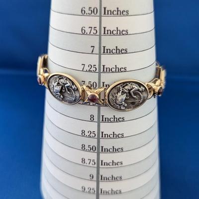 14K and Sterling silver bracelet with 6 embossed silver scenes and 7 amethyst cabachons Safety latch