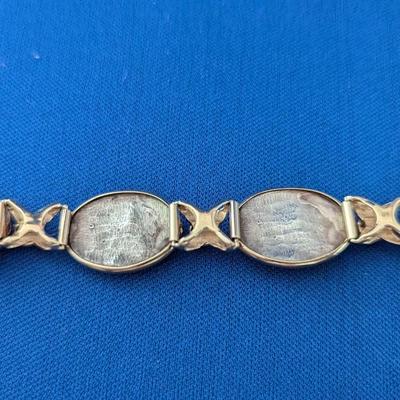 14K and Sterling silver bracelet with 6 embossed silver scenes and 7 amethyst cabachons Safety latch