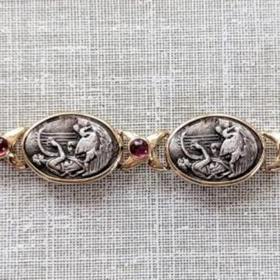 14K and Sterling silver bracelet with 6 embossed silver scenes and 7 amethyst cabachons Safety latch