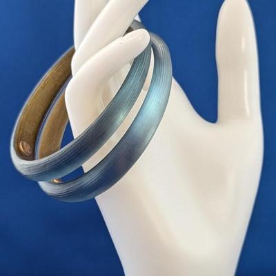 Pair of Alexis Bittar textured Lucite tapered bangle bracelets. Soft blue with gold inside.