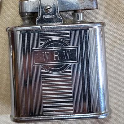 A GROUP OF WATCHES THAT NEED NEW BATTERIES AND A LIGHTER