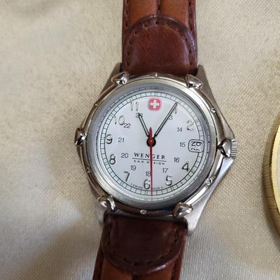 A GROUP OF WATCHES THAT NEED NEW BATTERIES AND A LIGHTER