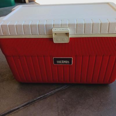 OZARK TRAIL FOLDING CHAIR, 2 FISHING POLES AND A COOLER