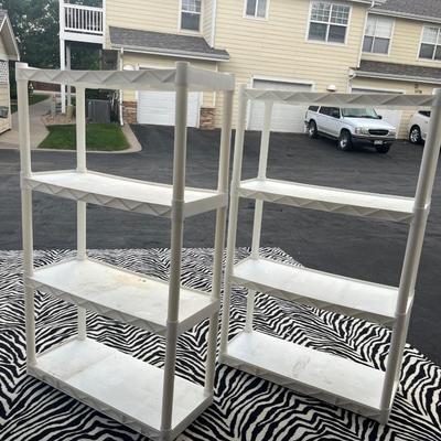 Two white plastic racks for shelves on each rack need to be cleaned otherwise in great shape