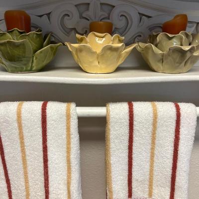 White shelf, towels, candleholders