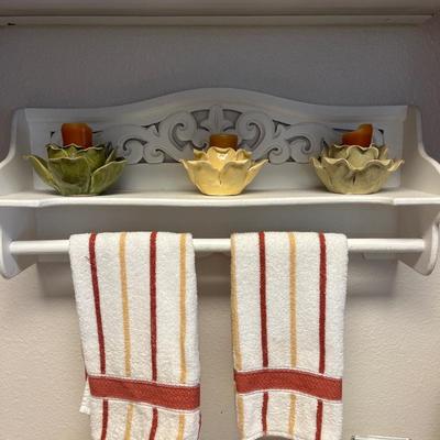 White shelf, towels, candleholders
