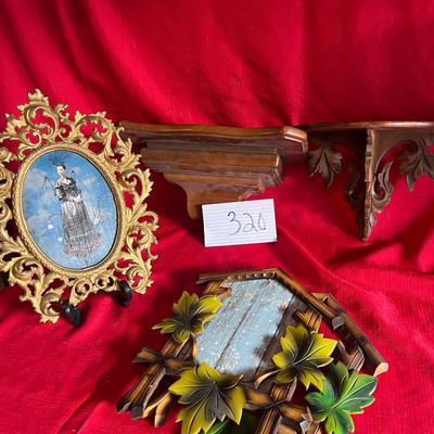 Variety of picture frames along with two small wall shelves for figurines or candles