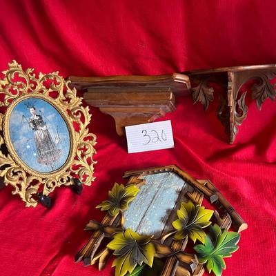 Variety of picture frames along with two small wall shelves for figurines or candles