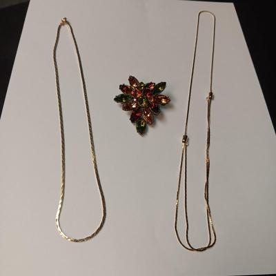RHINESTONE BROOCH AND 2 GOLD TONE CHAINS