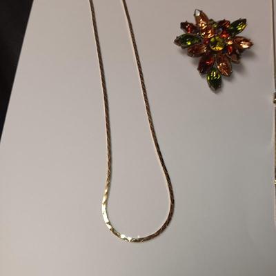 RHINESTONE BROOCH AND 2 GOLD TONE CHAINS
