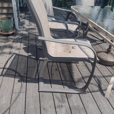 Metal Frame Patio Table with Glass Top, Four Chairs, and Umbrella