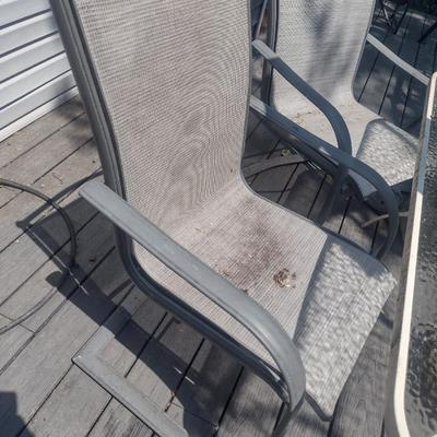 Metal Frame Patio Table with Glass Top, Four Chairs, and Umbrella