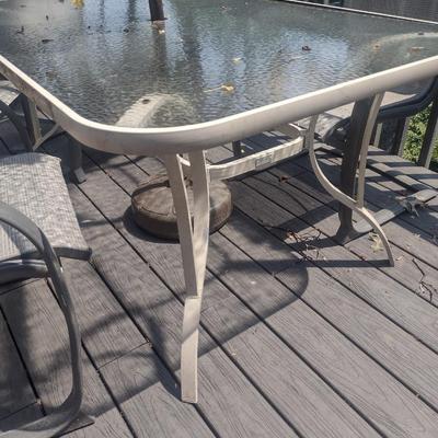 Metal Frame Patio Table with Glass Top, Four Chairs, and Umbrella