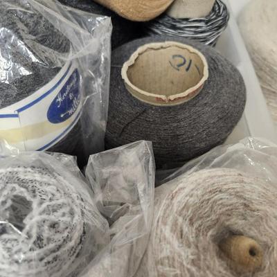 18 cones of yarn in greys