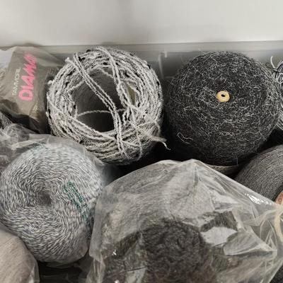 18 cones of yarn in greys