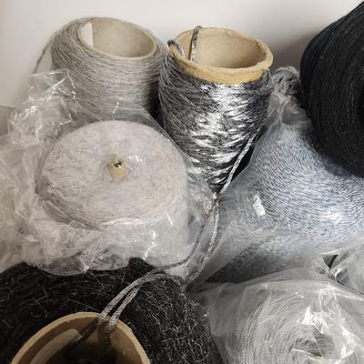 18 cones of yarn in greys