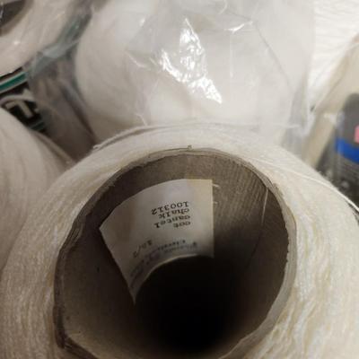 16 cones of yarn in whites