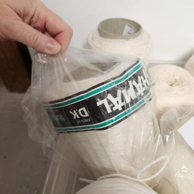 16 cones of yarn in whites