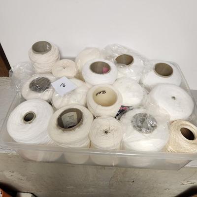 16 cones of yarn in whites