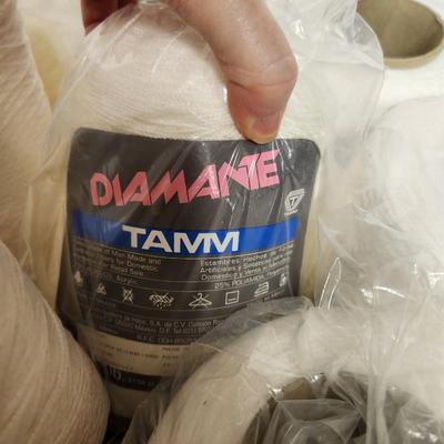 16 cones of yarn in whites