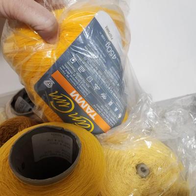 20 cones of yarn in yellow