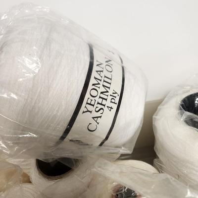 14 cones of yarn in white