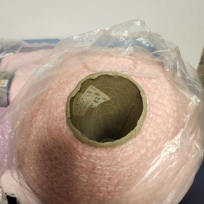 26 cones of yarn in pink