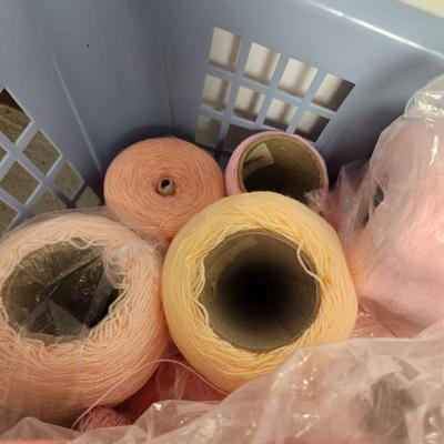 26 cones of yarn in pink
