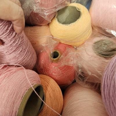 26 cones of yarn in pink